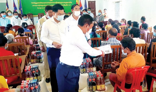 Kampong Speu provincial governor Vey Samnang distributes equity cards to poor families. Supplied