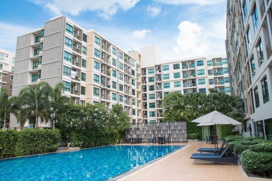 8-storey residential condo building with a swimming pool in the middle of the building.