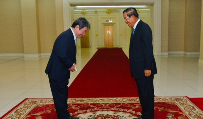 Cover pix Japan's Foreign Minister Motegi Toshimitsu greets Prime Minister Hun Sen during their meeting on Saturday. KT/Khem Sovannara